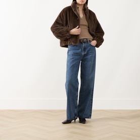 Model wearing Max Mara Weekend Anemone Faux Fur Jacket in brown with blue wide-leg jeans and black heeled boots.