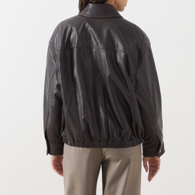 Model wearing Max Mara Weekend dark brown leather jacket, rear view, elasticated hem, zip front, styled with taupe trousers.