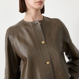 Model wearing Max Mara Main Bouquet Cropped Leather Jacket in kaki, collarless with gold-tone front buttons and raglan sleeves, smooth lamb leather