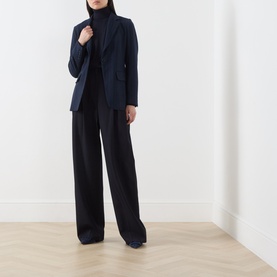 Model wearing Max Mara Main ultramarine wool blazer jacket, styled with black turtleneck and wide-leg trousers.