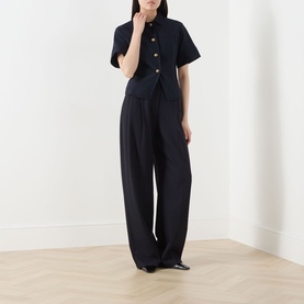 Model wearing Max Mara Main ultramarine cotton jacket with gold buttons, styled with wide-leg navy trousers and black heels.