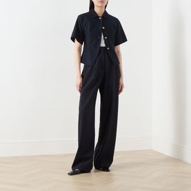 Model wearing Max Mara Main ultramarine cotton short-sleeve jacket, styled with wide-leg tailored trousers and white top.