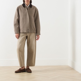 Model wearing Max Mara Weekend Festa Check Print Bomber Jacket in brown, with corduroy collar, styled with wide-leg trousers and loafers
