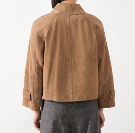 Model wearing Max Mara Weekend hazelnut goat leather jacket, rear view, with grey check trousers visible at hem.