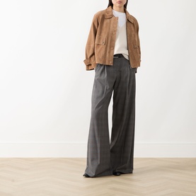 Model wearing Max Mara Weekend hazelnut leather jacket, styled with white top and grey wide-leg trousers.