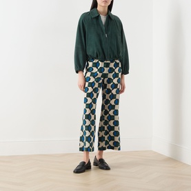 Model wearing Max Mara Weekend Zuppa Suede Jacket in dark green with zip fastening, styled with geometric-print wide-leg trousers and black loafers.