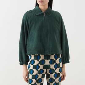 Model wearing Max Mara Weekend Zuppa Suede Jacket in dark green with point collar and front zip, styled with geometric print trousers.