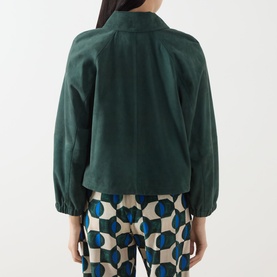 Model wearing Max Mara Weekend Zuppa Suede Jacket in dark green, back view, with geometric-print trousers. Bracelet sleeves, elasticated cuffs,