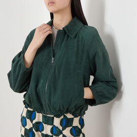 Model wearing Max Mara Weekend Zuppa Suede Jacket in dark green with zip fastening and point collar, styled with printed wide-leg trousers
