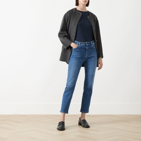 Model wearing Max Mara Weekend Lana Cropped Straight Leg Jeans in Navy Medium, styled with a dark grey coat, navy top, and black loafers.