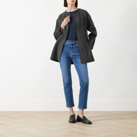 Model wearing Max Mara Weekend Lana Cropped Straight Leg Jeans in Navy Medium, styled with a dark coat and black loafers.
