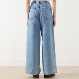 Model wearing Max Mara Weekend Zattera Wide Leg Jeans in blue, rear view showing wide-cut legs, five-pocket style and elasticated waistband