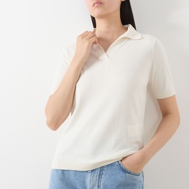 Model wearing Max Mara Weekend Roncolo Knit Polo Shirt in ecru, featuring spread collar, short sleeves and ribbed trims, styled with light blue jeans