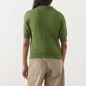 Model wearing Max Mara Weekend Albero Open Collar Knitted Polo Shirt in green, short sleeves, puff shoulders, ribbed trims, styled with beige