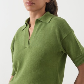 Model wearing Max Mara Weekend Albero Open Collar Knitted Polo Shirt in green, showing open placket, puff shoulders and ribbed trims.