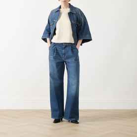 Model wearing Max Mara Weekend Addotto Knit Sweater in ecru, styled with wide-leg blue denim jeans and an oversized denim jacket.