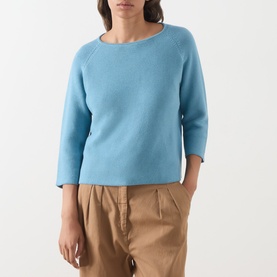 Model wearing Max Mara Weekend Addotto Knit Sweater in light blue with round neck and three-quarter sleeves, styled with tan trousers.