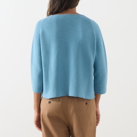 Model wearing Max Mara Weekend Addotto Knit Sweater in light blue, rear view, showing round neck, three-quarter sleeves and straight hem, styled with
