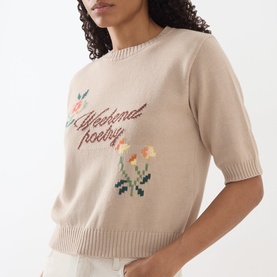 Model wearing Max Mara Weekend sand knit short-sleeve sweater with floral "Weekend Poetry" intarsia script detail