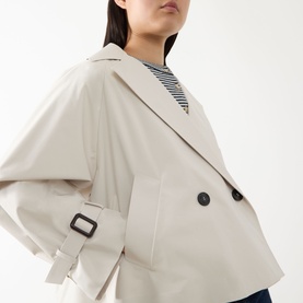 Model wearing Max Mara Weekend Boero Water-Repellent Jacket in Ivory Bicolour, double-breasted with black buttons and tab cuffs, styled with a