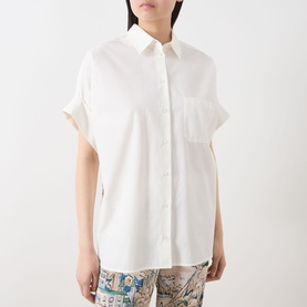 Model wearing Max Mara Weekend white cotton and silk short-sleeve shirt with chest pocket, styled with printed trousers.