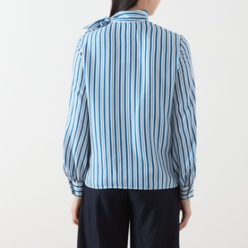 Model wearing Max Mara silk pinstripe shirt, back view, bow neck detail, long sleeves, styled with navy trousers