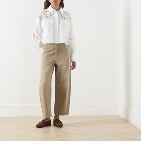 Model wearing Max Mara Weekend Ariano Lace Cut-Out Blouse in White Lace, cropped length with lace detail, styled with taupe wide-leg trousers and
