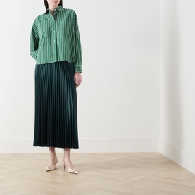 Model wearing Max Mara Weekend Onore Stripe Shirt in Green Big Stripe with dark green pleated midi skirt and cream flats.