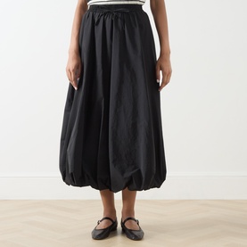 Model wearing Max Mara Weekend Ciurma Bubble Skirt in black, midi length with elasticated waist and gathered bubble hem, styled with black mary jane