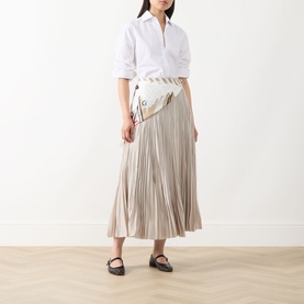 Model wearing Max Mara Weekend ivory pleated midi skirt, styled with white shirt, belt bag and black flat shoes.