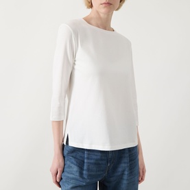 Model wearing Max Mara Weekend Multia Logo Top in white, with round neckline, three-quarter sleeves and split side seams, styled with blue jeans.