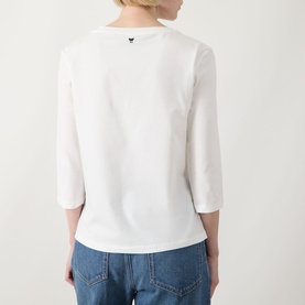 Model wearing Max Mara Weekend Multia Logo Top in white, showing rear view with three-quarter sleeves and butterfly logo detail, styled with blue