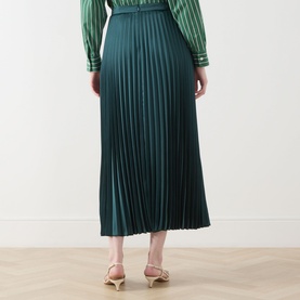 Model wearing Max Mara Weekend Nicchia Pleated Skirt in dark green, midi length with wide waistband, styled with a striped green top and nude heeled