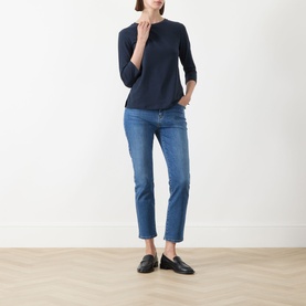 Model wearing Max Mara Weekend Multia Stretch Top in navy, with three-quarter sleeves, styled with blue cropped jeans and black loafers.