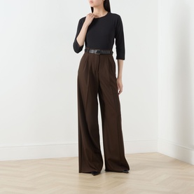 Model wearing Max Mara Weekend Multia Solid T-Shirt in black with boat neck and three-quarter sleeves, styled with wide-leg brown trousers and belt.