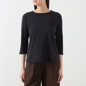 Model wearing Max Mara Weekend Multia Solid T-Shirt in black with boat neckline and three-quarter sleeves, styled with brown wide-leg trousers.