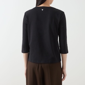 Model wearing Max Mara Weekend Multia Solid T-Shirt in black, showing rear view with logo detail at neck, three-quarter sleeves, paired with brown