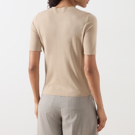 Model wearing Max Mara Weekend Tapioca Fine-Knit Sweater in sand, back view, crew neck, short sleeves, styled with grey trousers