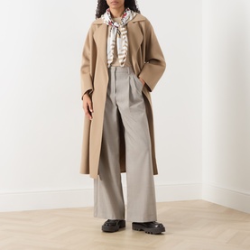 Model wearing Max Mara Weekend Tapioca Fine-Knit Sweater in sand, styled with a printed scarf, wide-leg trousers and black loafers.