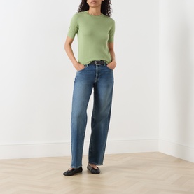 Model wearing Max Mara Weekend green wool-silk-cashmere T-shirt, styled with blue straight-leg jeans and black flat shoes.
