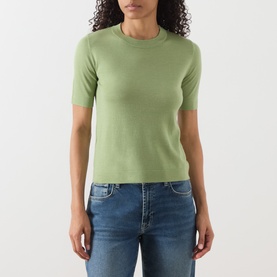 Model wearing Max Mara Weekend green wool-silk-cashmere knit T-shirt with crew neck and short sleeves, styled with blue jeans.