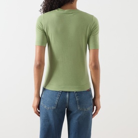 Model wearing Max Mara Weekend green wool-silk-cashmere T-shirt, back view, styled with blue denim jeans.