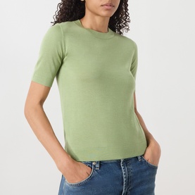 Model wearing Max Mara Weekend green wool-silk-cashmere T-shirt with crew neck and short sleeves, styled with blue jeans.