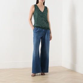 Model wearing Max Mara Weekend Milord Embellished Knitted Vest in green with V-neck and sequin detail, styled with wide-leg blue jeans and strappy