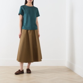 Model wearing Max Mara Weekend Gilvert Fluid Blouse in green with khaki midi skirt and brown loafers