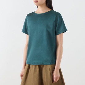 Model wearing Max Mara Weekend Gilvert Fluid Blouse in green, round neckline, short sleeves, smooth satin fabric, styled with khaki midi skirt