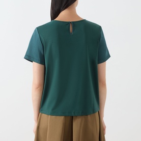 Model wearing Max Mara Weekend Gilvert Fluid Blouse in green, back view showing keyhole fastening, styled with khaki wide-leg trousers