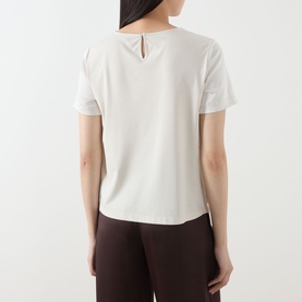 Model wearing Max Mara Weekend Gilbert Solid Blouse in ivory, rear view showing keyhole back detail, short sleeves, styled with dark trousers.