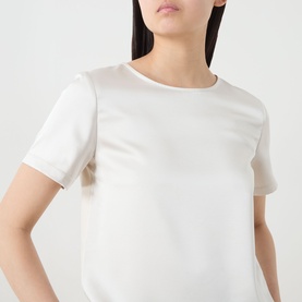 Model wearing Max Mara Weekend Gilbert Solid Blouse in ivory, satin finish, crew neckline, short sleeves, straight hem