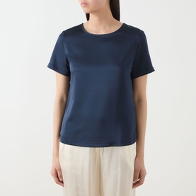 Model wearing Max Mara Weekend Gilbert Solid Blouse in navy, satin finish, crew neckline, short sleeves, paired with cream wide-leg trousers